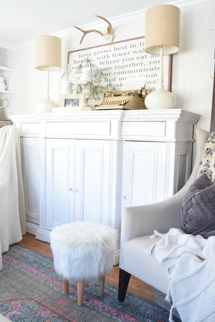 White painted cabinet - love the pair of matching white lamps and furry stool kellyelko.com