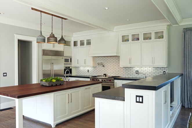 Gorgeous white kitchen with subway tile and black grout and look at that amazing vintage light fixture kellyelko.com