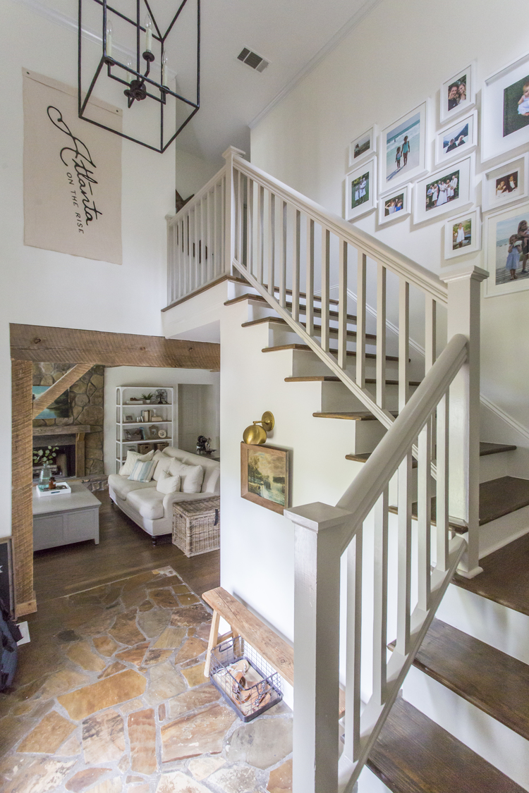 Classic foyer and bannister - love the gallery wall kellyelko.com