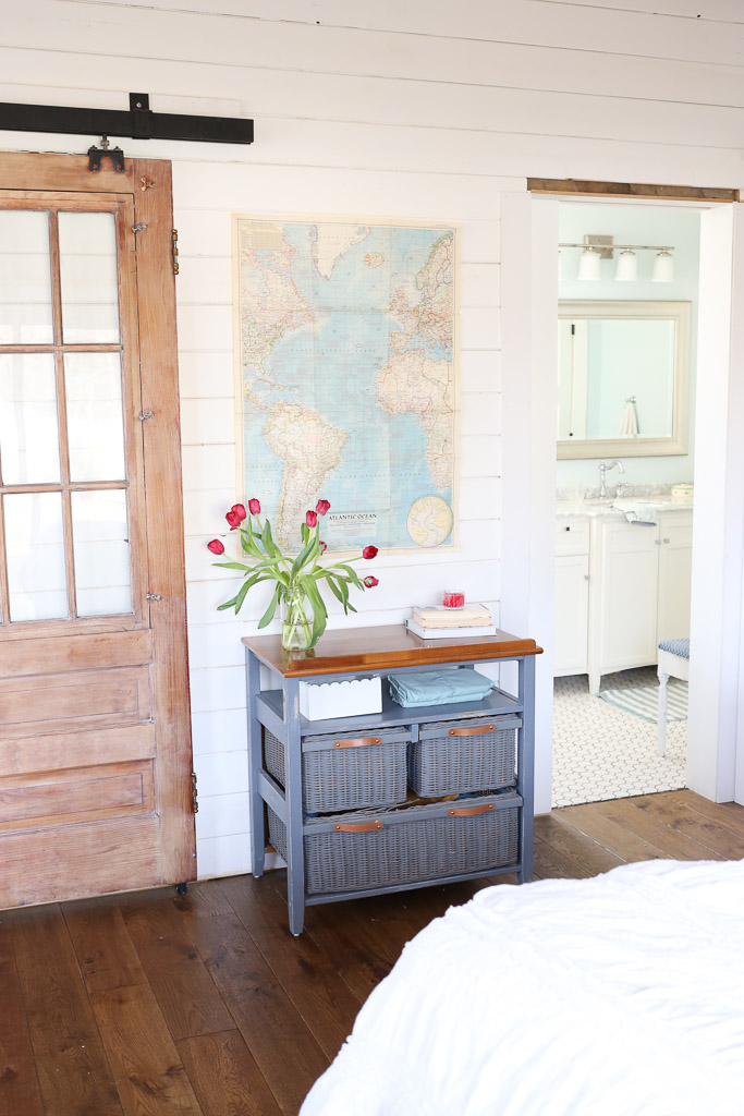 Love the sliding barn door and white planked walls in this cozy bedroom kellyelko.com