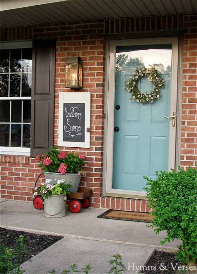 Summer front porch - love the blue door and the old wagon filled with flowers kellyelko.com