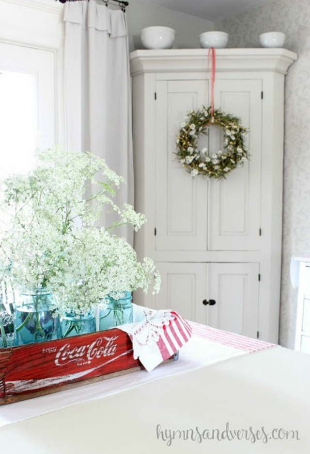 Old Coke crate filled with mason jars and flowers makes a great centerpiece kellyelko.com