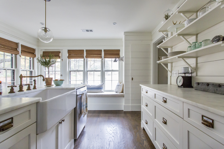 Beautiful white kitchen with tons of charming details like the brass pulls and faucet and huge farmhouse sink kellyelko.com