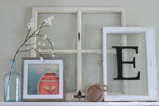 Love this mantel display - a couple of old windows with a colorful piece of art and add a nautical touch kellyelko.com