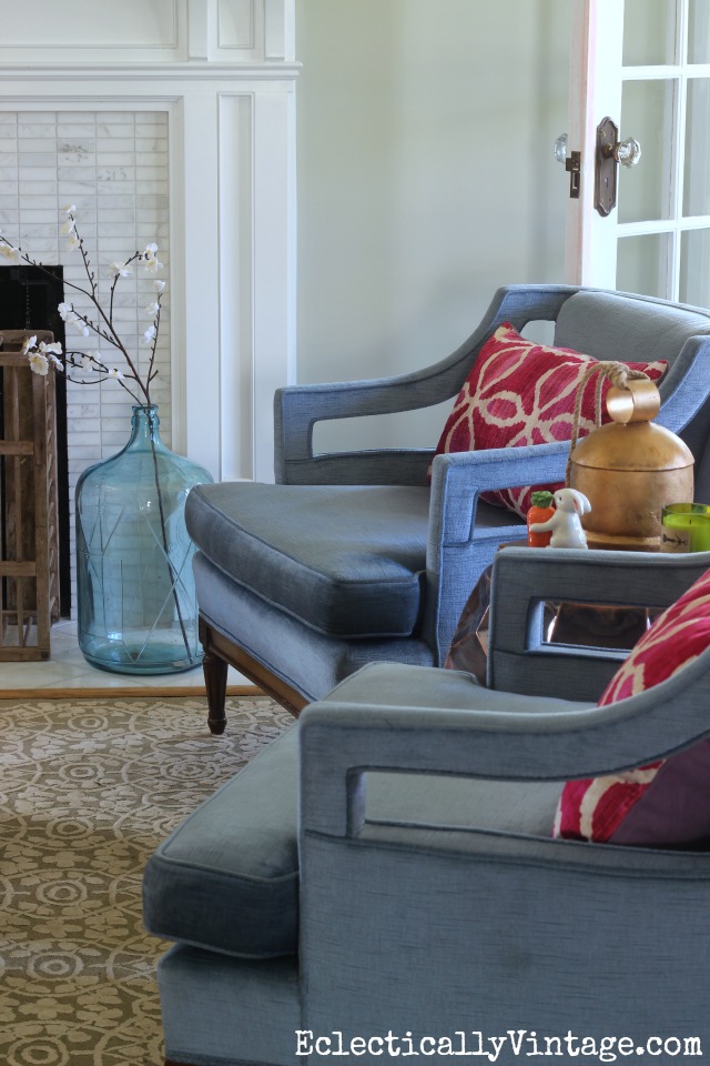 Add a interest to chairs with an unexpected color and pattern like these pink ikat pillows on the vintage club chairs kellyelko.com