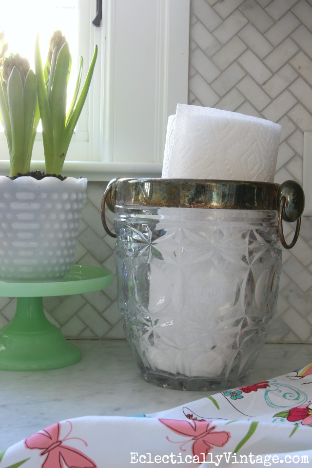 Great idea for a paper towel holder - a vintage ice bucket! Love these quick and easy kitchen decorating ideas kellyelko.com