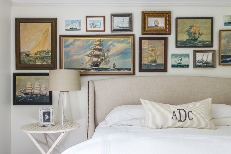 Love this vintage painting gallery wall over a bed kellyelko.com