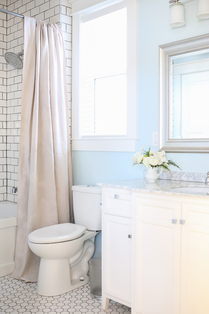 Black and white bathroom - love the white subway tile with black grout and the blue walls kellyelko.com