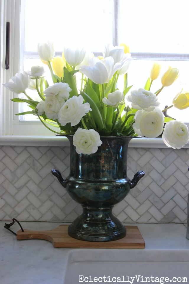 Love this monochromatic flower arrangement in an old silver champagne bucket kellyelko.com 