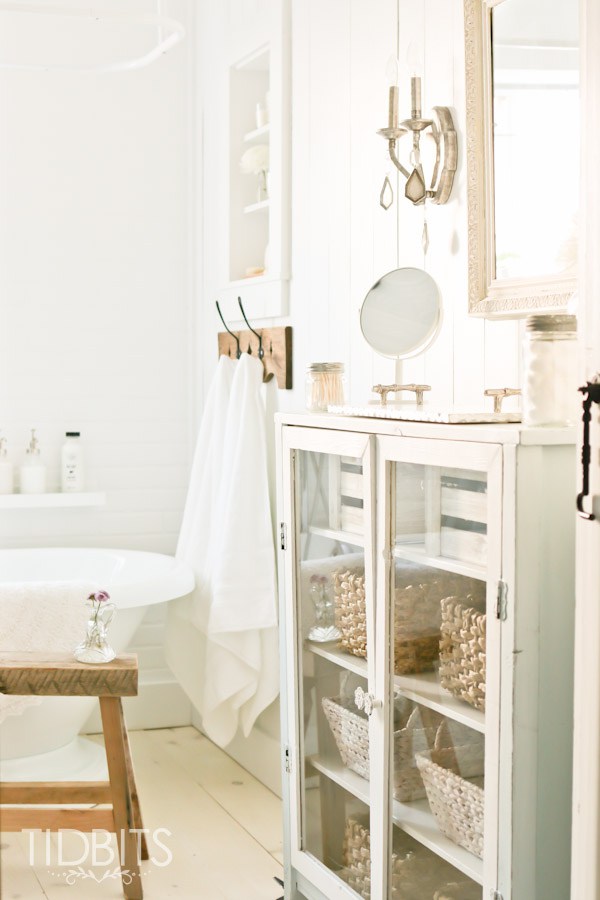 Use a piece of furniture in the bathroom for storage and farmhouse appeal kellyelko.com