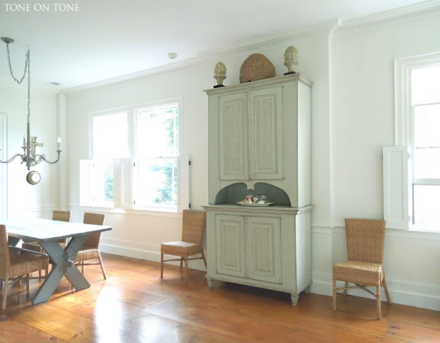 Antique pine floors stand out in a white dining room kellyelko.com