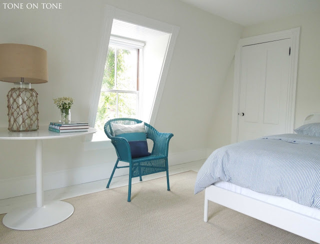 Attic bedroom - love the pop of color from the peacock blue chair kellyelko.com