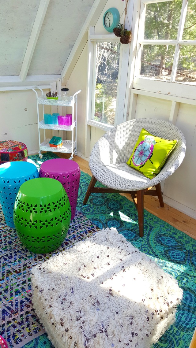 Colorful outdoor furniture decorates this very cool treehouse kellyelko.com