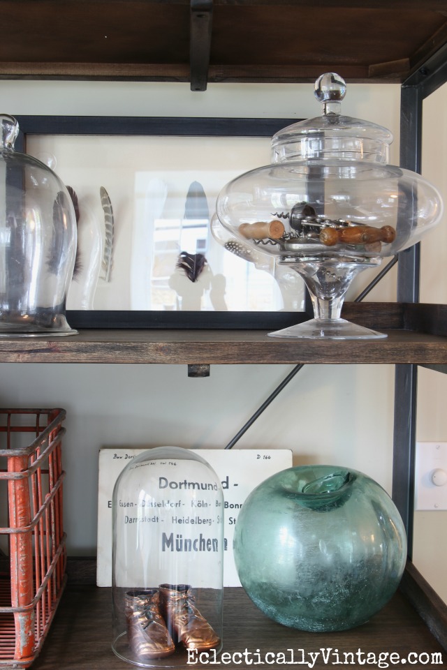 Eclectic shelf display - love the collection of corkscrews in the glass jar kellyelko.com