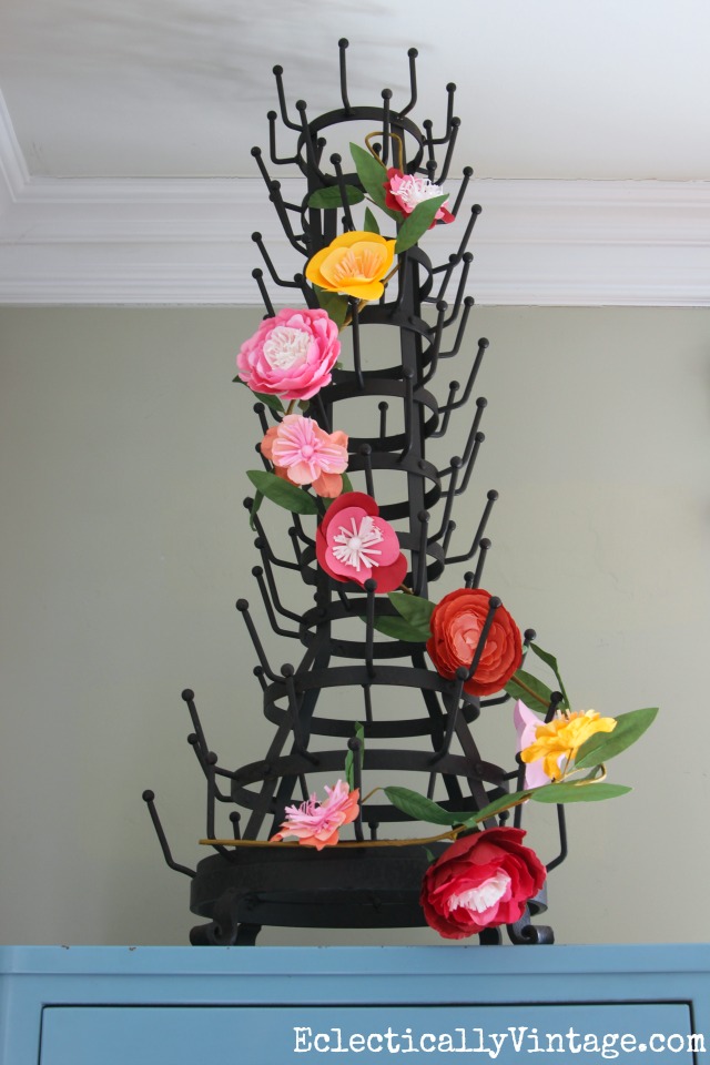 Love this huge bottle drying rack with the flower garland for spring kellyelko.com