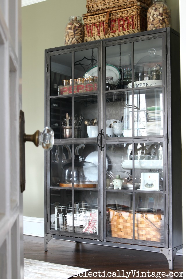 Love this glass front industrial cabinet - perfect for storage in the dining room kellyelko.com