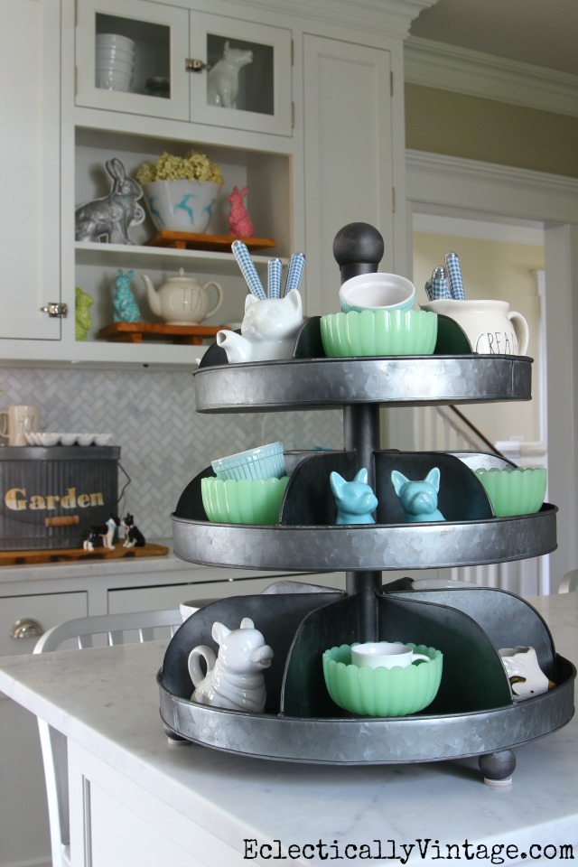 I love tiered trays for displaying favorite things on the kitchen counter like this mix of jadeite and white bowls kellyelko.com #spring #springdecor #springdecorating #springcrafts #hometour #housetour #eclectichome #farmhousedecor #fixerupperstyle #jadeite #farmhousestyle #vintagedecor #vintagehome #kellyelko #industrialdecor #whitekitchen #kitchendecor 