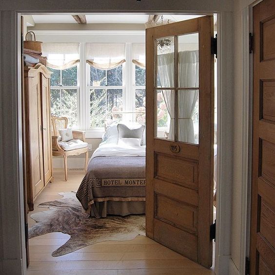 Love this guest bedroom - the old glass door is so charming kellyelko.com