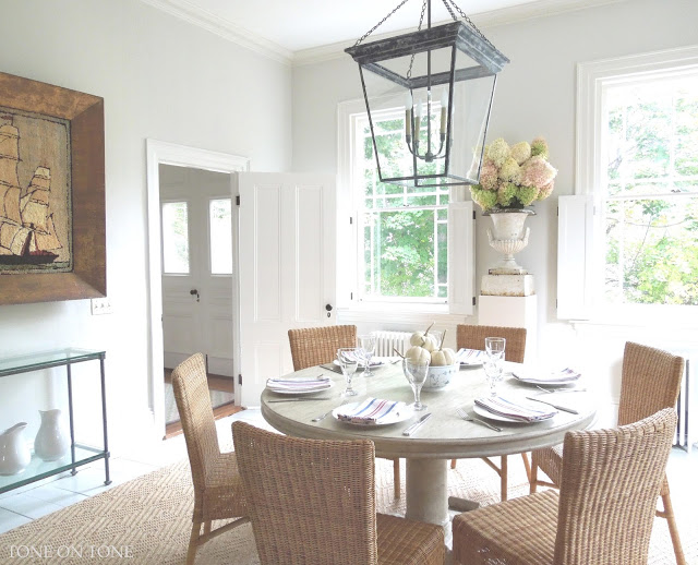 Love the round dining table, rattan chairs and huge lantern kellyelko.com