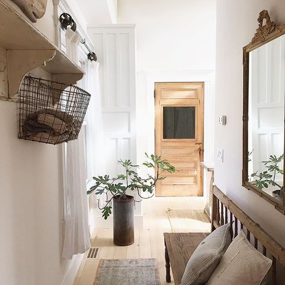 Beautiful hallway - love the wood bench and that glass door! kellyelko.com