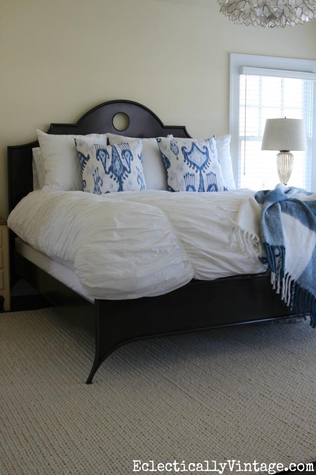 Love this neutral textured rug in this master bedroom - it is the perfect complement to the black metal bed kellyelko.com