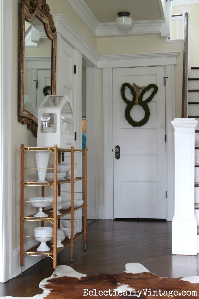 Fresh spring foyer with a beautiful collection of milk glass and a cute bunny wreath kellyelko.com