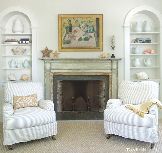 Symmetrical bookshelves flank the fireplace kellyelko.com