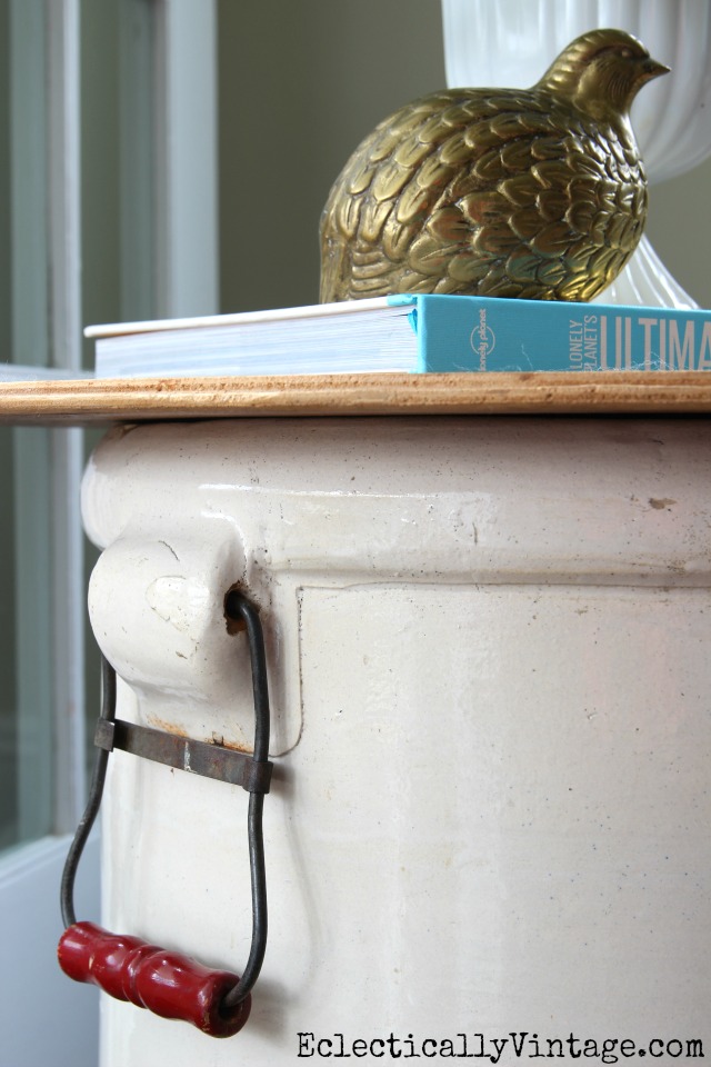 Love the red and metal handles on this huge old crock turned table kellyelko.com