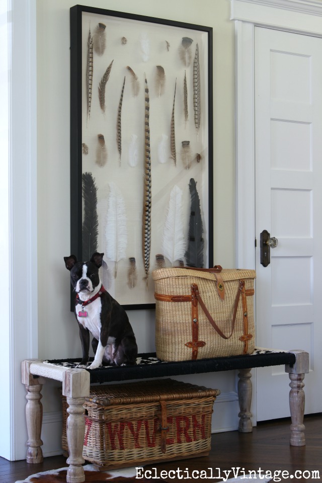 Love this woven black and white Chindi bench combined with the feather art in this foyer kellyelko.com