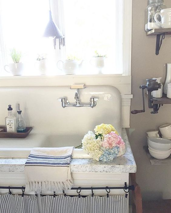 Antique drainboard sink in this charming farmhouse kitchen kellyelko.com