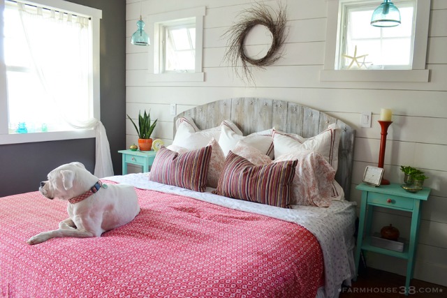 Love this cozy cottage bedroom with rustic barn wood headboard and planked walls kellyelko.com