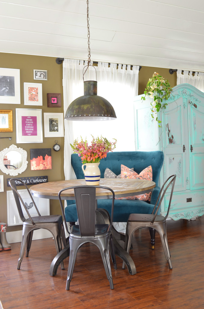 Colorful dining area - love her colorful, eclectic style and the blue settee kellyelko.com 