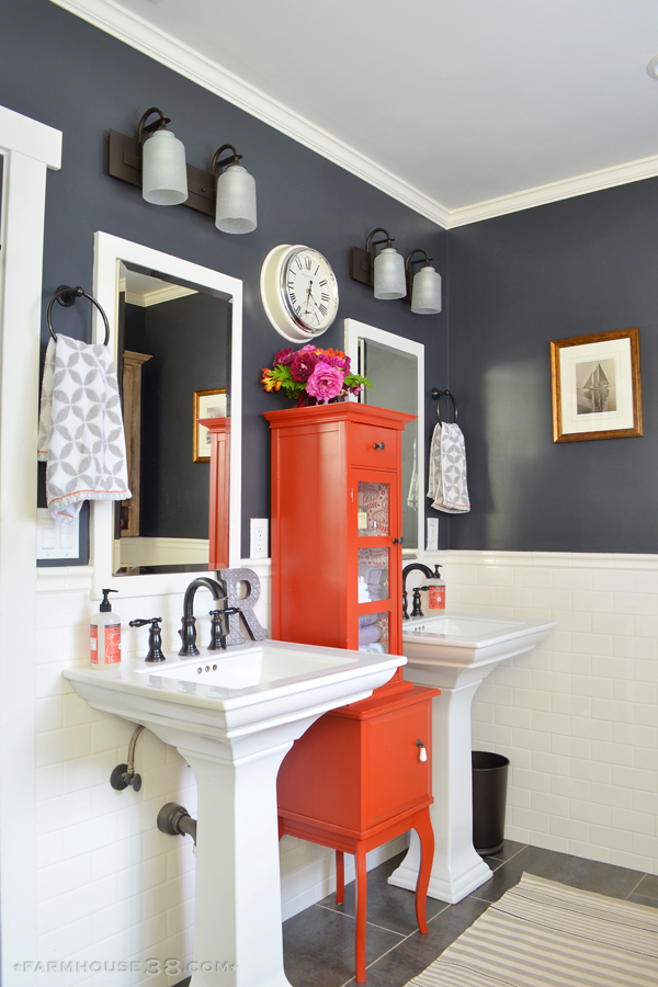 Colorful master bathroom - love the dark paint paired with lots of white and a fun pop of color with the red cabinet kellyelko.com