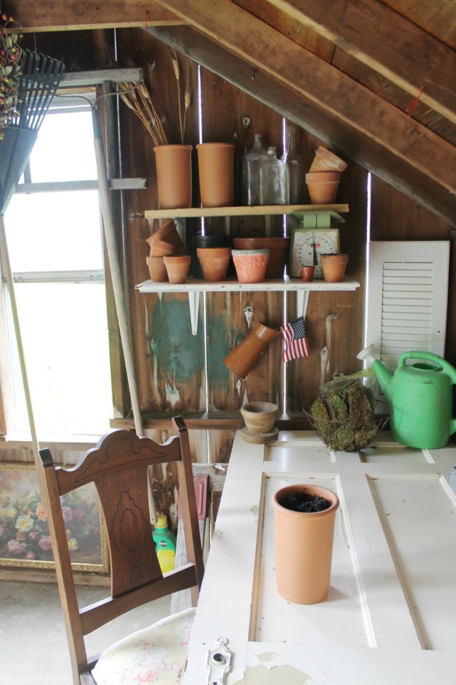 Old door turned desk in a rustic potting shed kellyelko.com