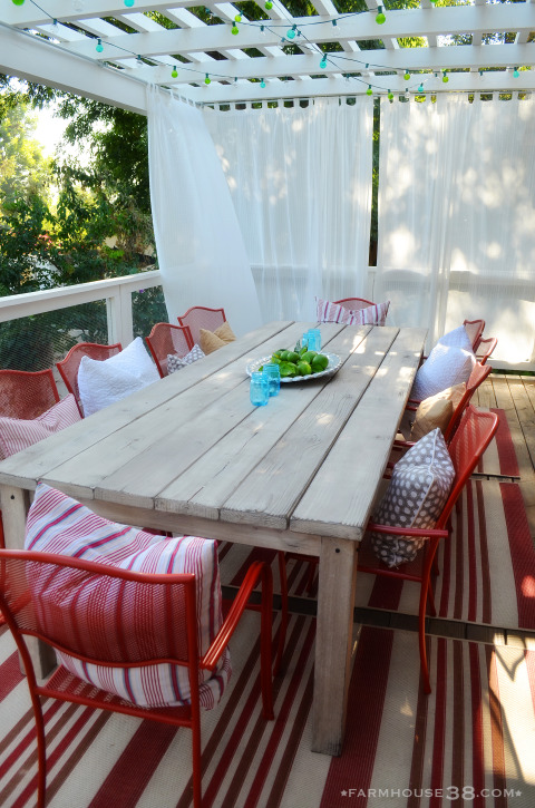 Create a cozy outdoor dining space with a pergola - love the big farm table and red chairs kellyelko.com