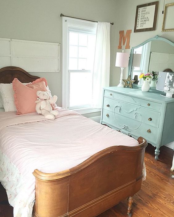 Such a cute farmhouse girls bedroom - love the antique bed and the painted blue dresser kellyelko.com