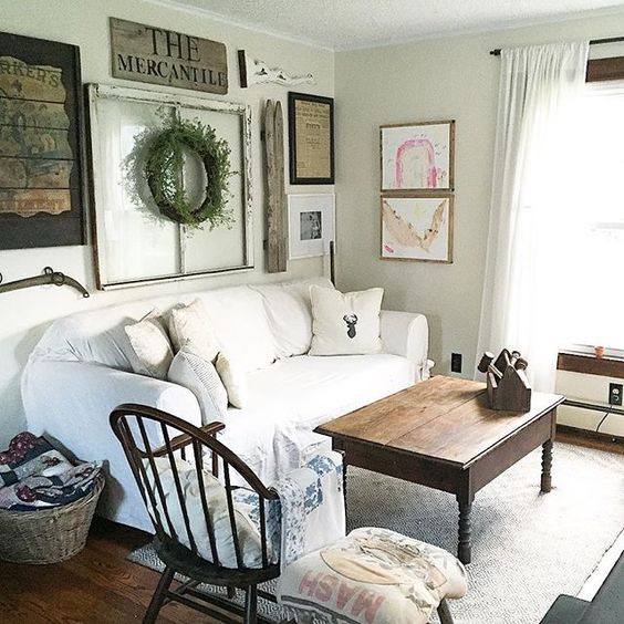 Love this neutral family room with slipcovered sofa and eclectic gallery wall kellyelko.com