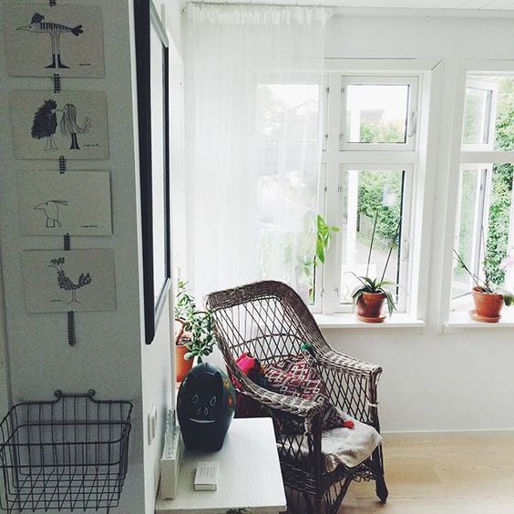 Cozy reading nook - love the wicker chair and all the plants on the windowsill kellyelko.com