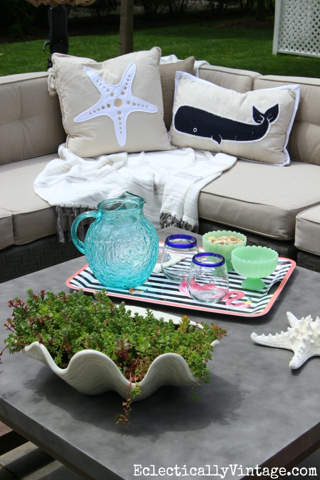 Love this patio! The concrete coffee table is beautiful and the sectional sofa is a cozy place to curl up kellyelko.com