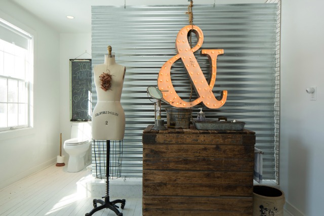 Corrugated metal makes a perfect privacy screen in this farmhouse bathroom kellyelko.com