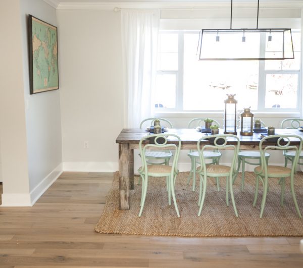 Eclectic dining room with a mix of farmhouse table and mint green bentwood chairs kellyelko.com
