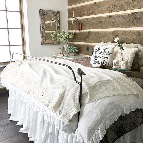 Rustic wood plank walls in this cozy master bedroom and love the little bird on the iron bed kellyelko.com