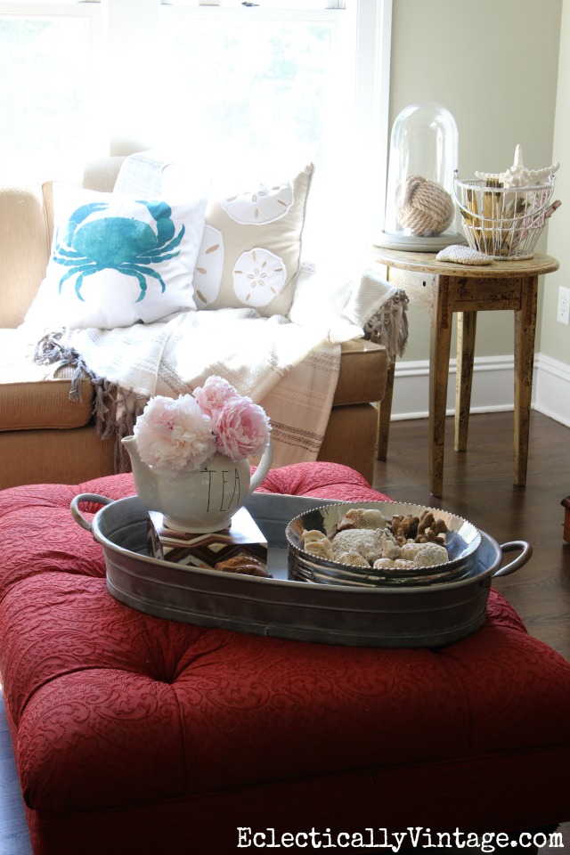 Coastal family room - love the crab pillow, shells, coral and rope monkey ball kellyelko.com