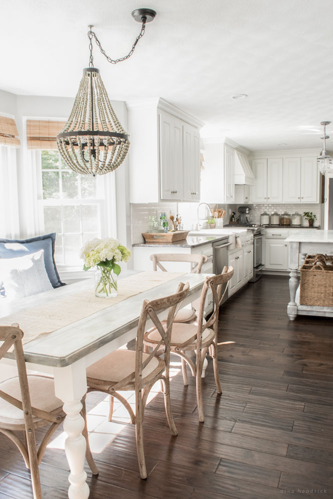 Farmhouse kitchen - love the mismatched furniture and beaded chandelier kellyelko.com