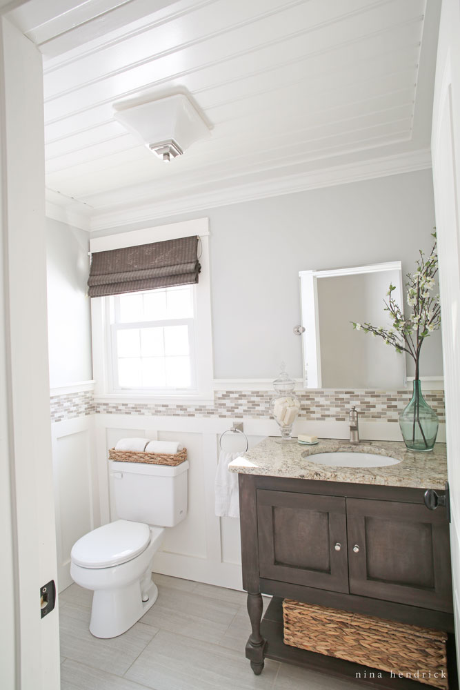 Love the details in this small powder room - the bead board ceiling and tile trim kellyelko.com