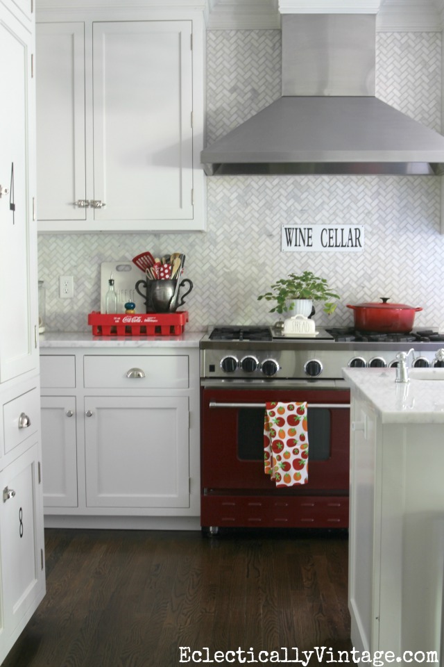 Gorgeous white kitchen with carrara marble herringbone tile backsplash kellyelko.com