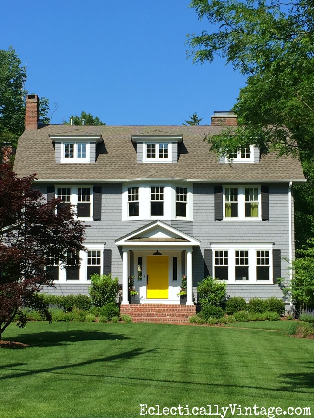 Curb appeal - love the gray house with a fun pop of color from a bright yellow door kellyelko.com