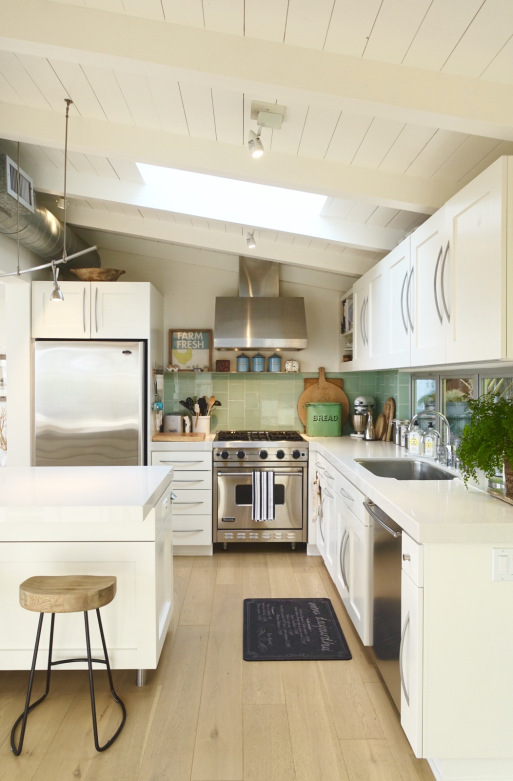 Small white kitchen big on style - love the planked ceiling and green glass tile backsplash kellyelko.com