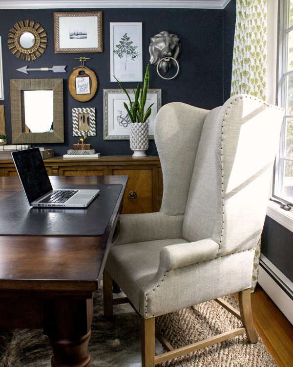 Dramatic dark walls in this home office with large desk and wing back chair kellyelko.com
