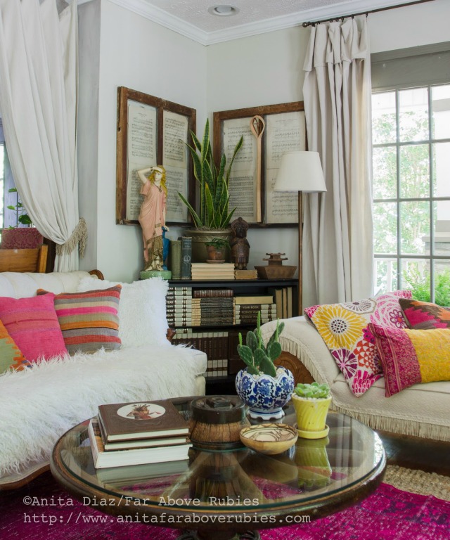 Boho chic family room - love the colorful pillows and wagon wheel table kellyelko.com